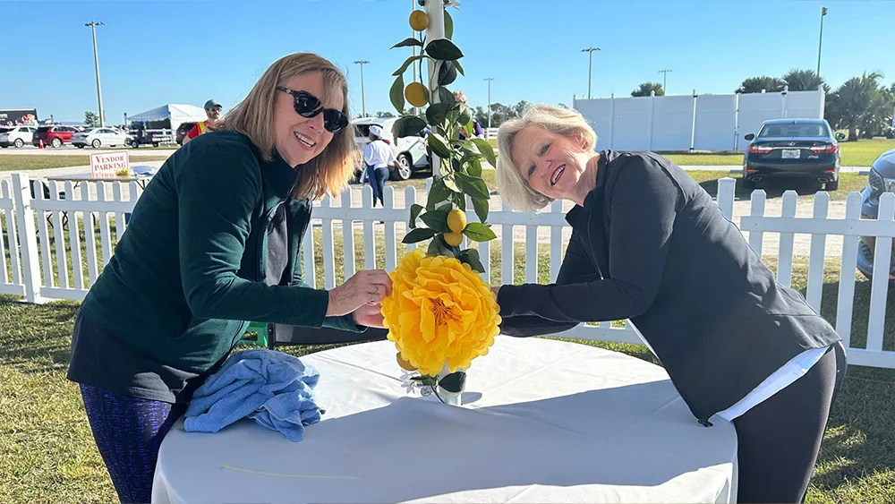 Two women decorating a table at Suncoast Food & Wine Fest