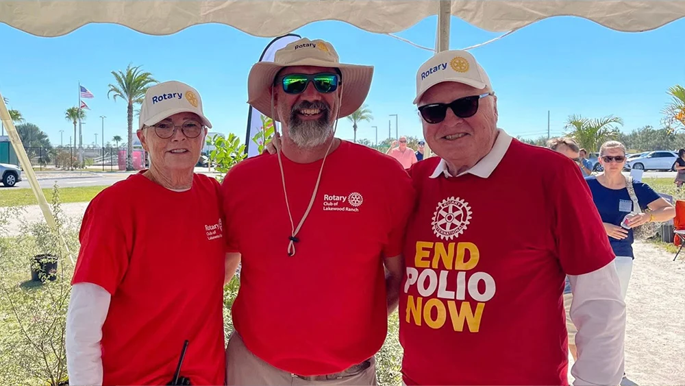 Three Rotary Club members posing at Suncoast Food & Wine Fest