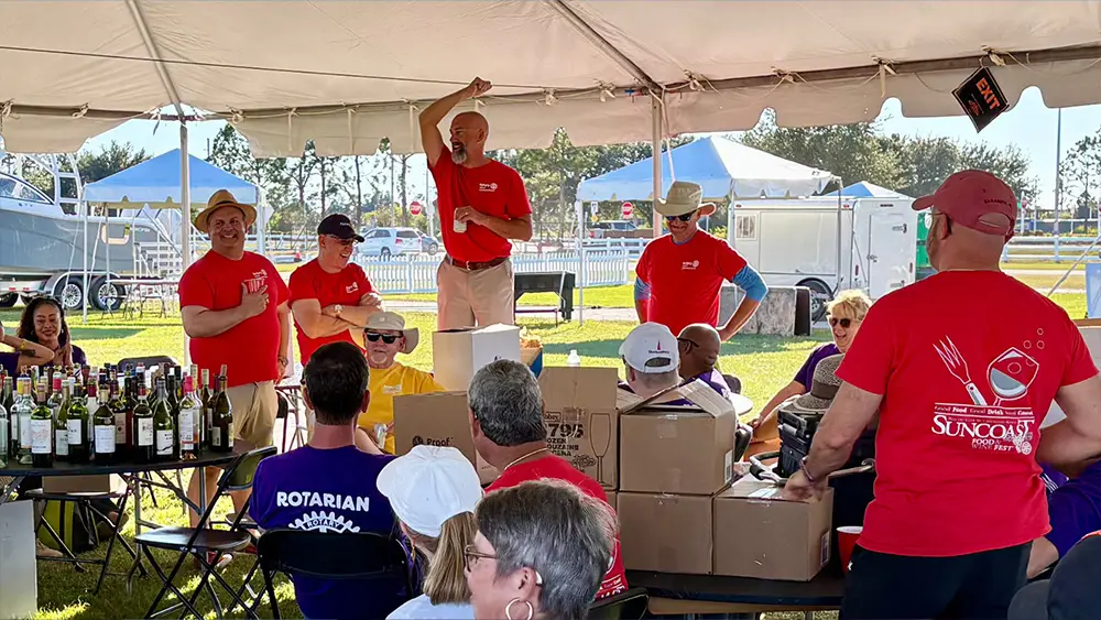 Rotary Club volunteers setting up supplies at Suncoast Food & Wine Fest